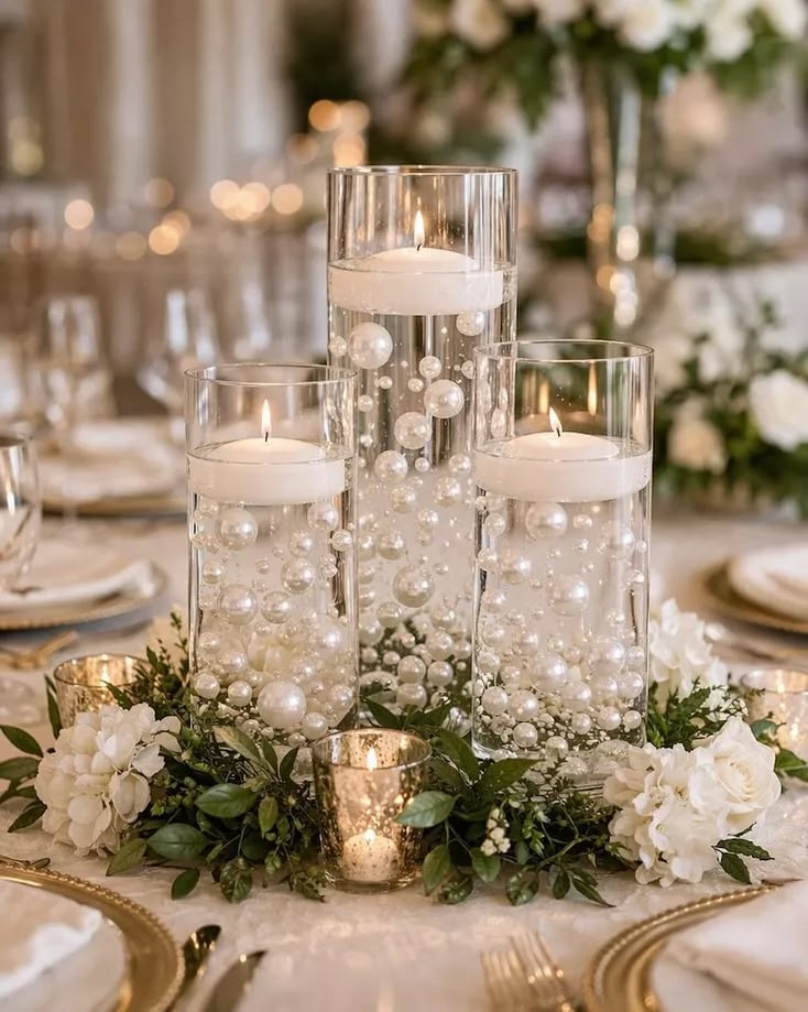 Floating candle centerpiece with pearls, white roses and greenery