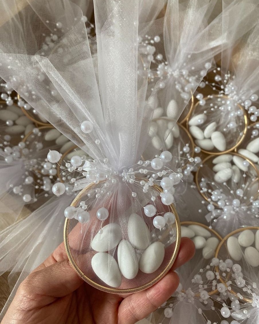 Sugared almond wedding favours wrapped in tulle with pearl sprays